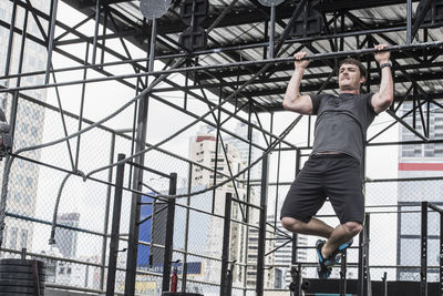 Man training at rooftop gym in bangkok