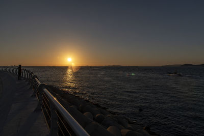 Scenic view of sea against clear sky during sunset