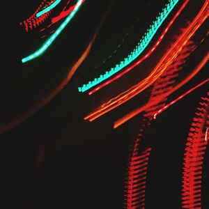 Close-up of illuminated light trails in darkroom