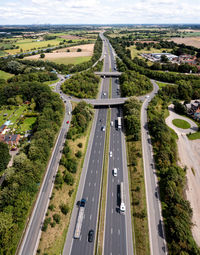 Aerial vertical panorama directly above a busy motorway intersection through countryside in the uk