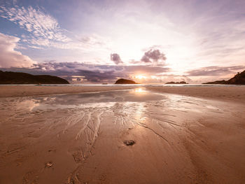 Scenic view of beach against sky during sunset