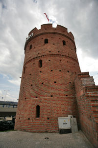 Low angle view of historical building against cloudy sky