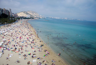 High angle view of people at beach against sky