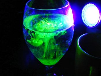 Close-up of drink in glass against black background