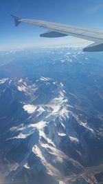 Cropped image of airplane flying over landscape