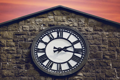 Low angle view of clock tower against sky