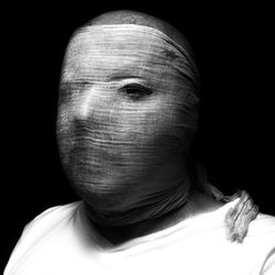 Close-up of human face against black background