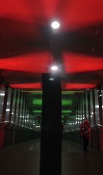 Blurred motion of man walking in illuminated subway station