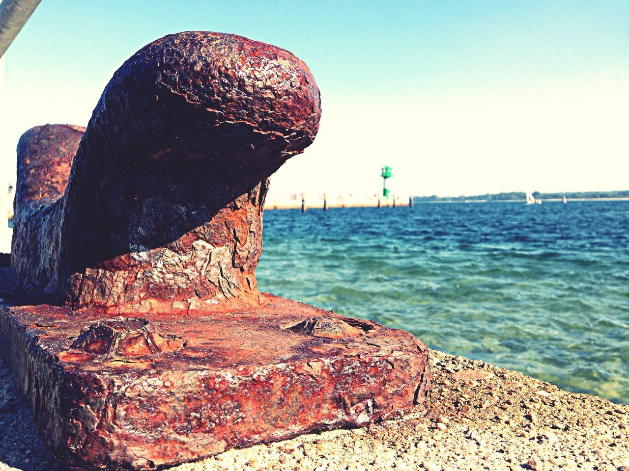 sea, water, rock - object, horizon over water, blue, sky, beach, clear sky, tranquility, scenics, tranquil scene, shore, rock formation, nature, beauty in nature, sunlight, rock, built structure, day, stone - object