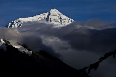 Low angle view of mountain against dramatic sky