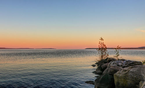 Scenic view of sea against clear sky during sunset