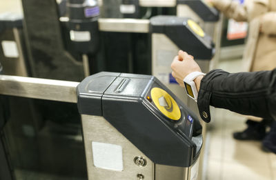 Uk, london, young woman paying ticket with her smartwatch at underground station