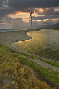 Scenic view of beach against sky during sunset