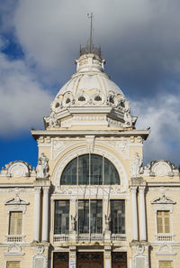 Low angle view of building against cloudy sky