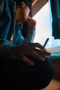 Close-up of man holding cigarette