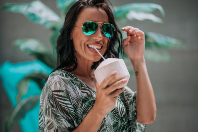 Portrait of a beautiful young woman drinking water