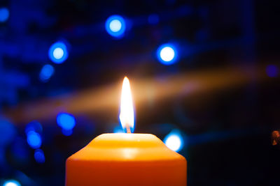 Close-up of lit candles in temple