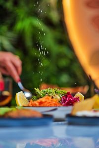 Cropped hand of woman preparing food