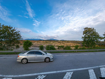 Cars on road against sky