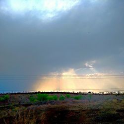 Scenic view of landscape against cloudy sky