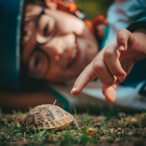 Close-up of hands on grass