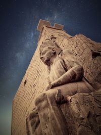 Low angle view of statue against sky at night