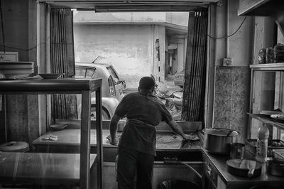 Rear view of man working in a food joint