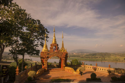 View of temple building against cloudy sky