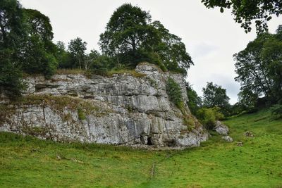 Scenic view of rocks on field against sky