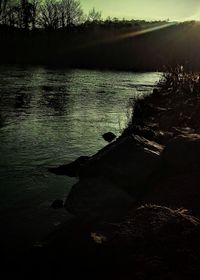 Scenic view of river at sunset