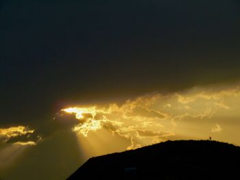 Low angle view of silhouette mountain against sky during sunset