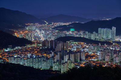 High angle view of illuminated buildings in city at night