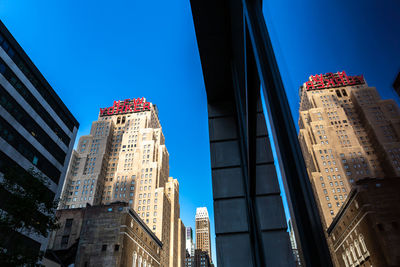 Low angle view of buildings against blue sky