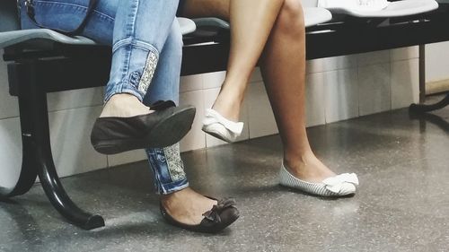 Low section of people sitting in kitchen