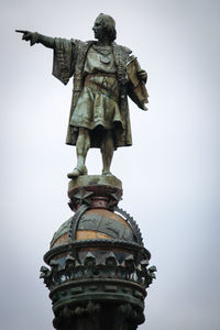 Low angle view of statue against sky