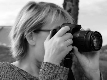 Close-up of woman photographing through digital camera