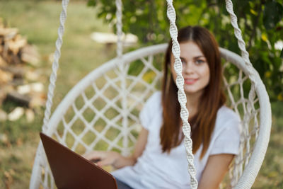 Portrait of young woman sitting on grass
