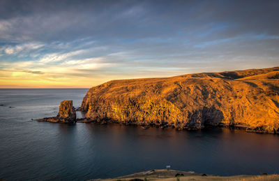 Scenic view of sea and rock formation against sky