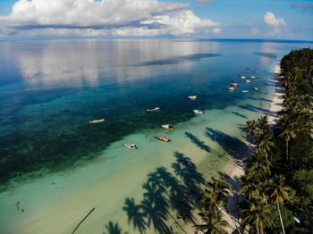 High angle view of boats on sea shore against sky