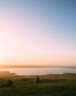 Scenic view of sea against clear sky during sunset