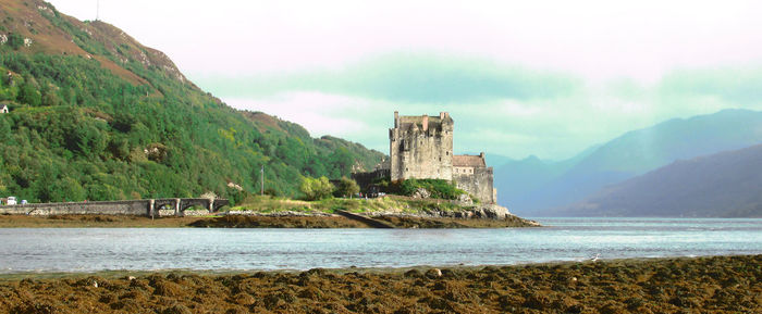 Panoramic view of sea and eilean donan castle against sky