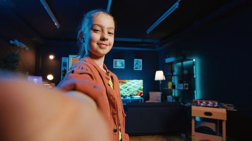 Portrait of young woman standing in nightclub