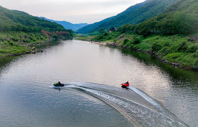 High angle view of people kayaking in sea