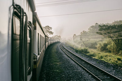 Train on railroad track against sky