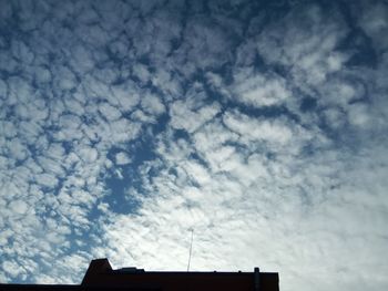 Low angle view of telephone pole against sky