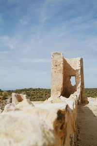 Old ruin building on field against sky