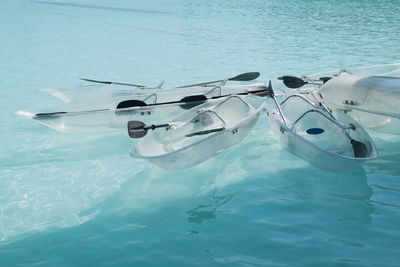 High angle view of transparent rowboats in sea