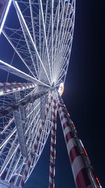 Low angle view of illuminated ferris wheel at night