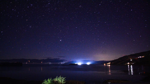 Scenic view of lake against star field at night