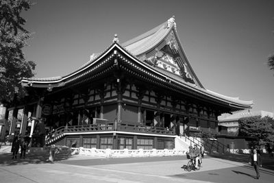 Group of people outside temple against building